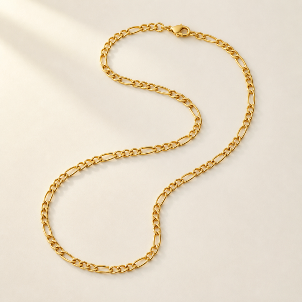 Fine 21K yellow-gold Figaro chain arranged in a soft curve